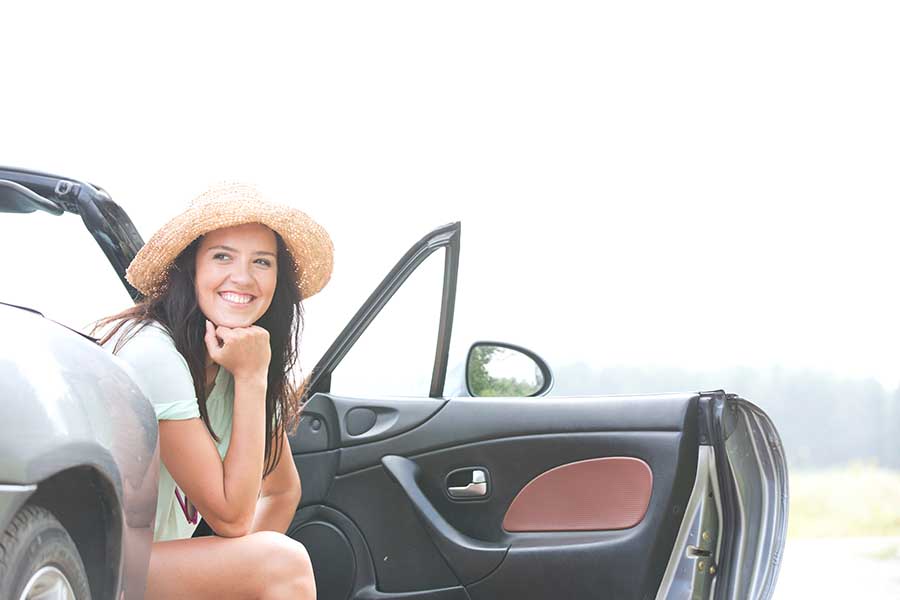 lady enjoying view from rented car