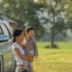 camping with kids. happy mother and son with spending time outdoor in the autumn park. we like autumn time together. first memories. family having a picnic beside their camper car.